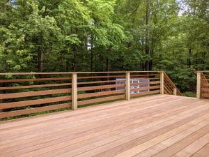Image of a deck in New Hampshire with a forest view.